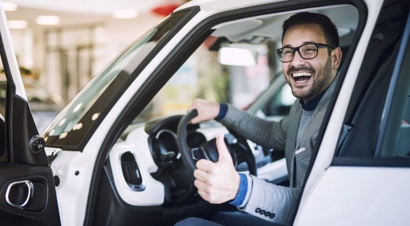 Happy satisfied customer just bought a brand new car at vehicle dealership. Happy satisfied customer just bought a brand new car at vehicle dealership.